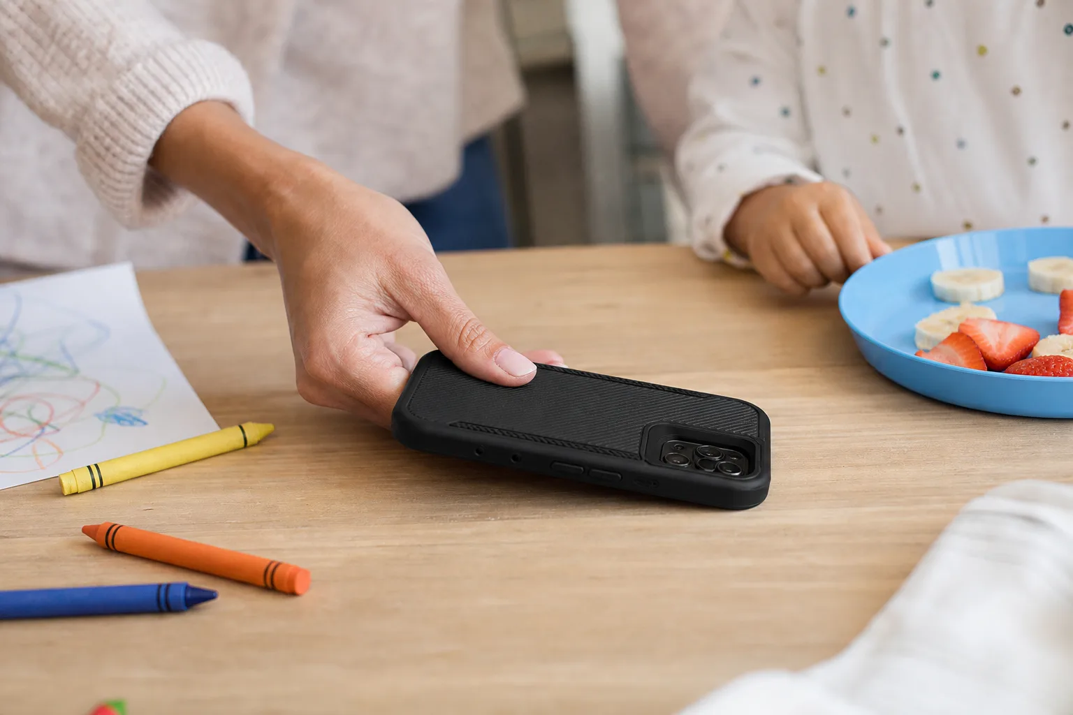 Lifestyle scene illustrating protective cases for parents with small kids